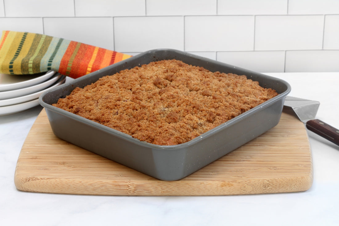 coffee cake in square bake pan sitting on top of cutting board